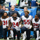 Members of the Houston Texans stand and kneel before the game against the Seattle Seahawks at CenturyLink Field on Oct. 29, 2017, in Seattle.